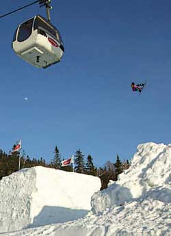 a snowboarder and gondola at mont tremblant ski resort 